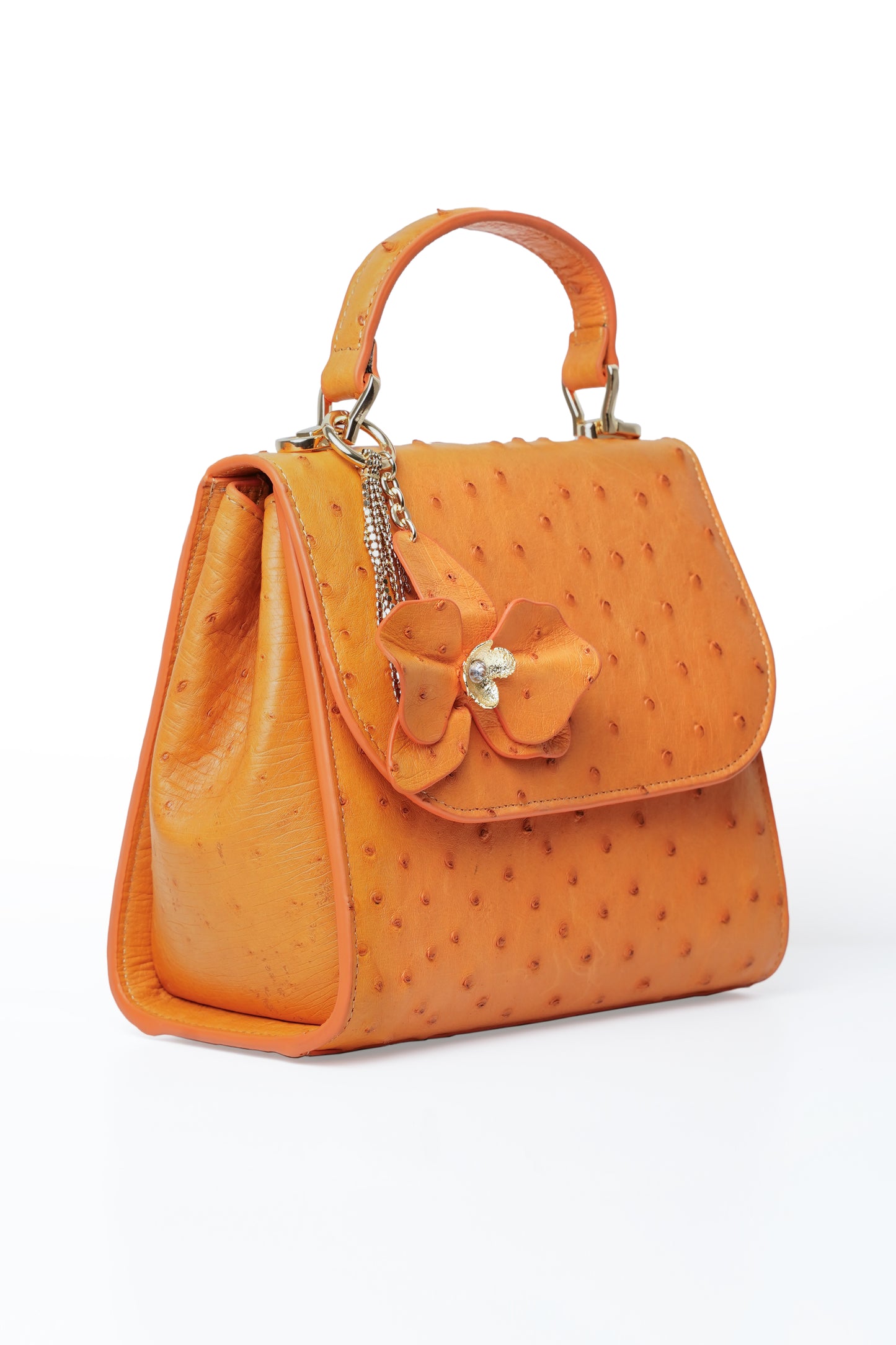 Orchid Bag made of 100% camel leather with orchid charm and removable chain strap.