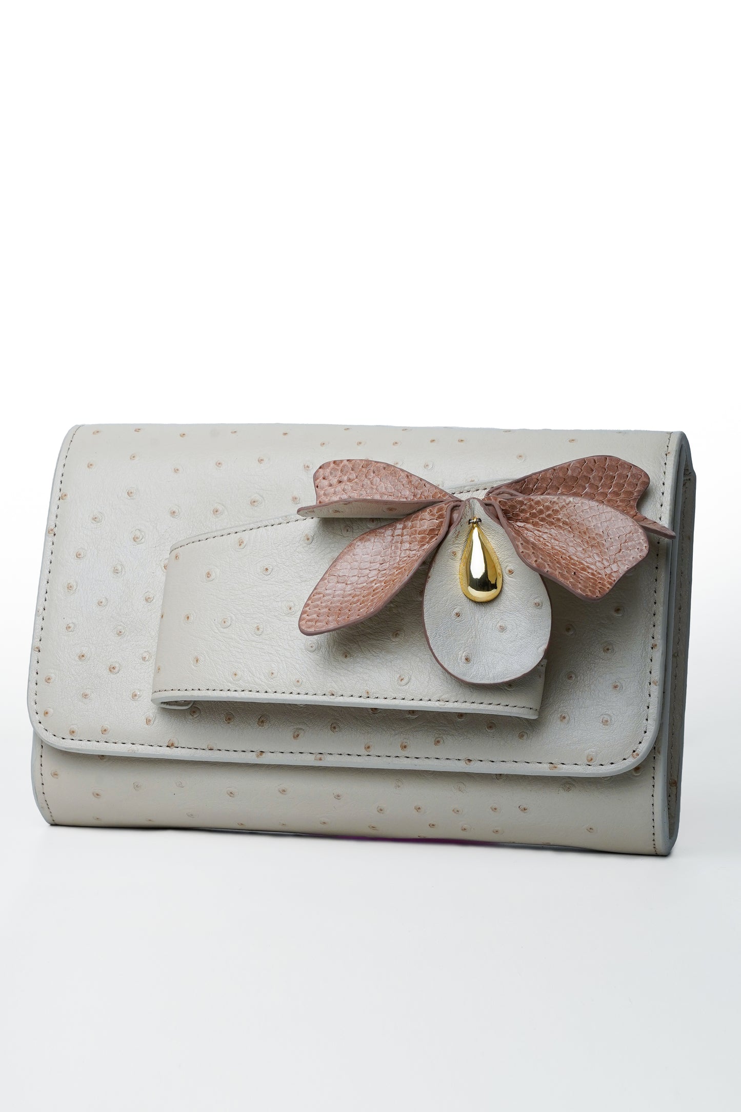 Ivory handbag with butterfly detail in python and ostrich leather with soft color tones.