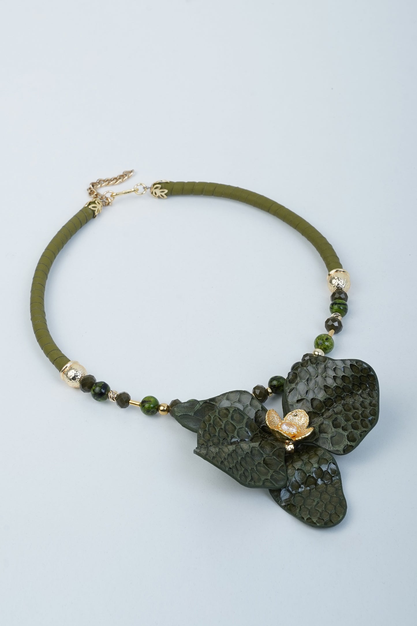 Handmade orchid necklace in black leather with brass flower detail