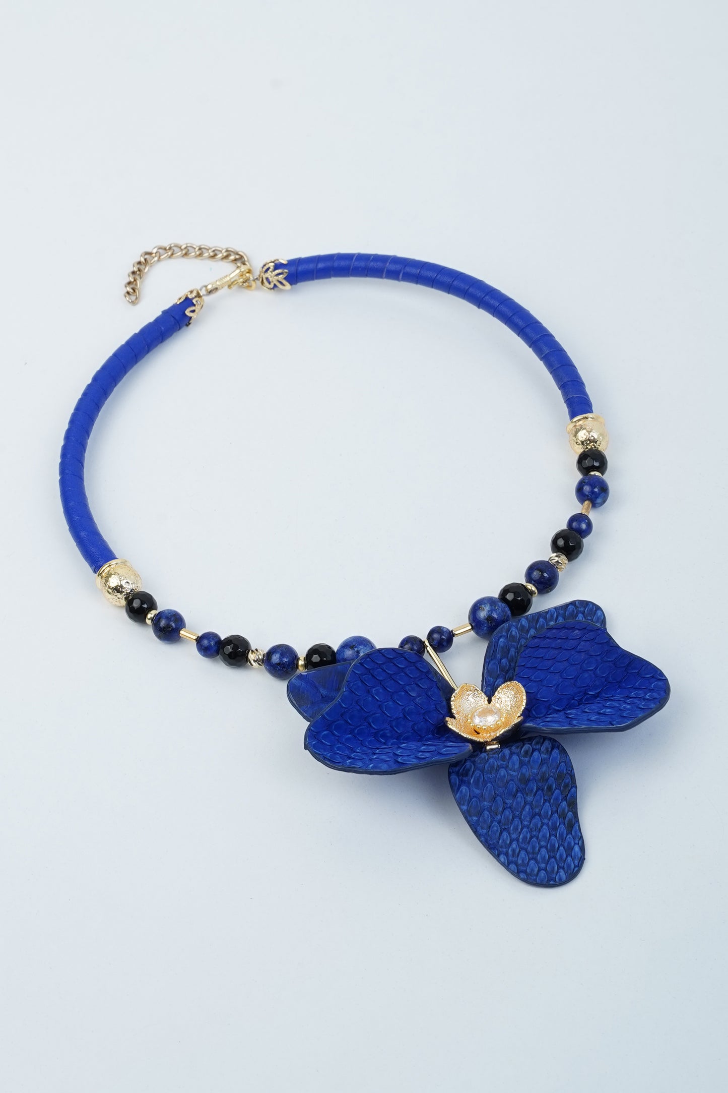 Handmade blue orchid flower necklace with leather and brass details