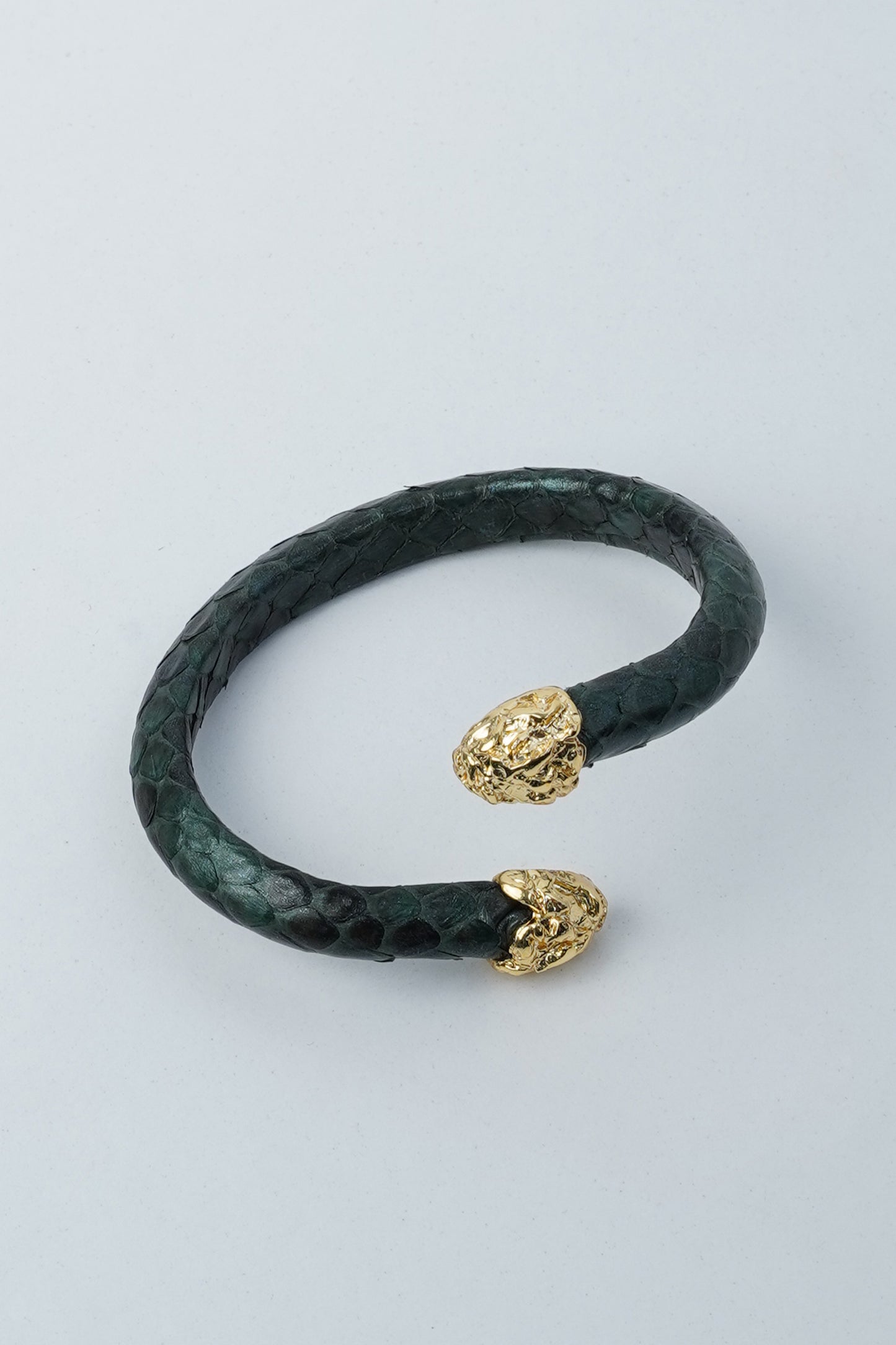 Hierapolis green handmade leather bracelet with gold-plated brass ends on light background