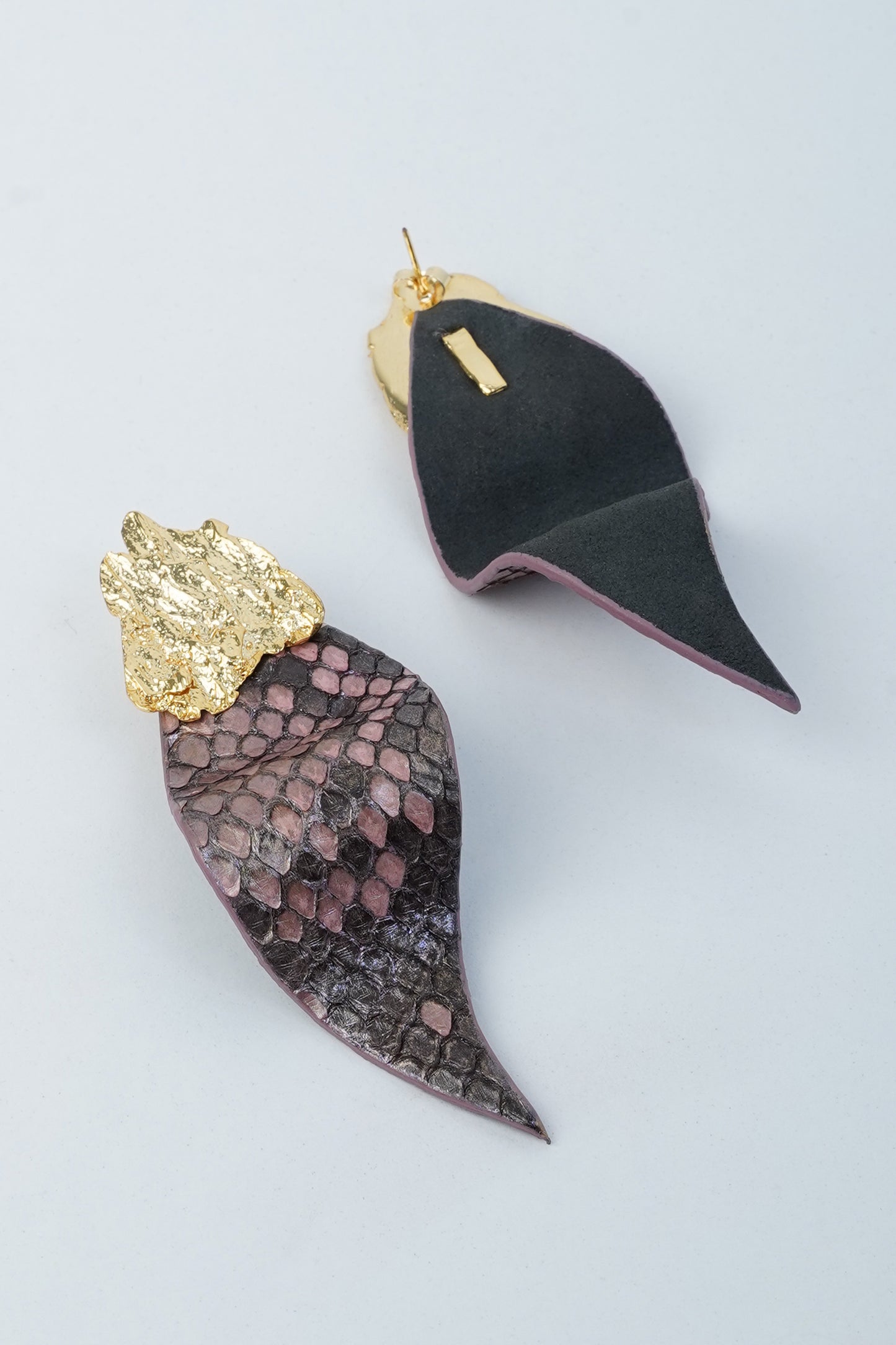 Purple eucalyptus leaf earrings with handcrafted brass details and textured leather finish.