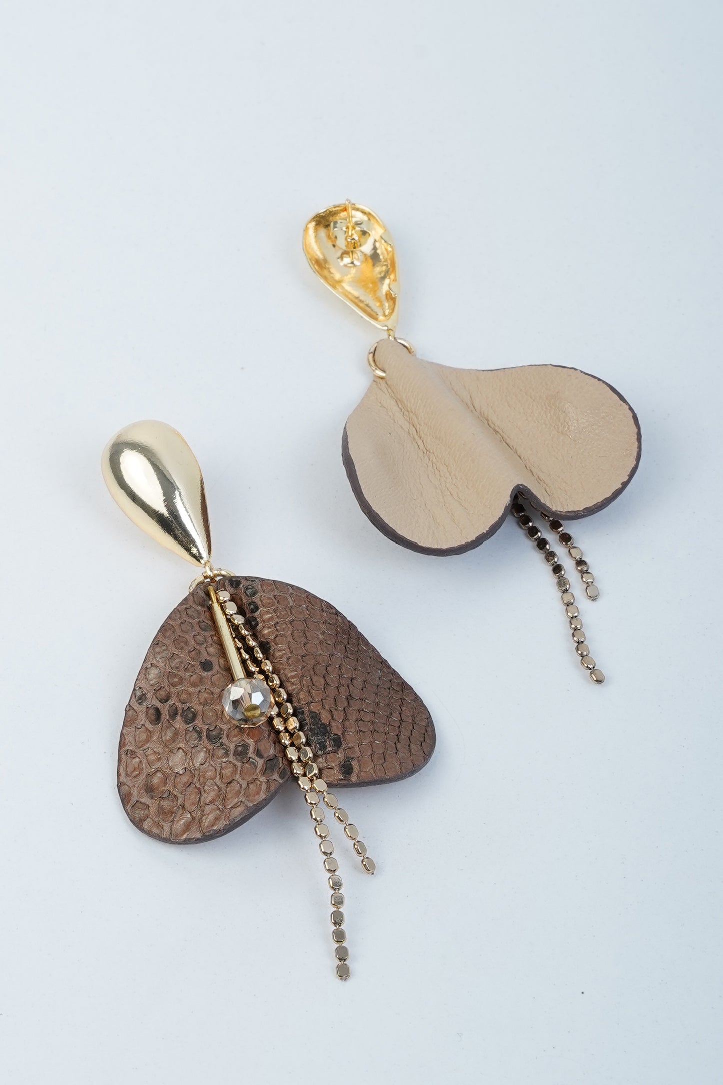 Gold-plated beige and brown heart-shaped leather earrings with chain detail, inspired by the Weeping Heart Flower.