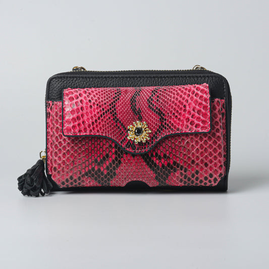 Raspberry-colored handmade python leather clutch bag with gold-plated details.