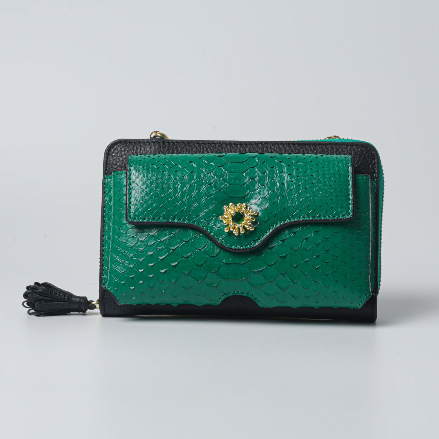 Handmade raspberry bag in green python leather with elegant clutch style, luxury craftsmanship, and gold-plated details.
