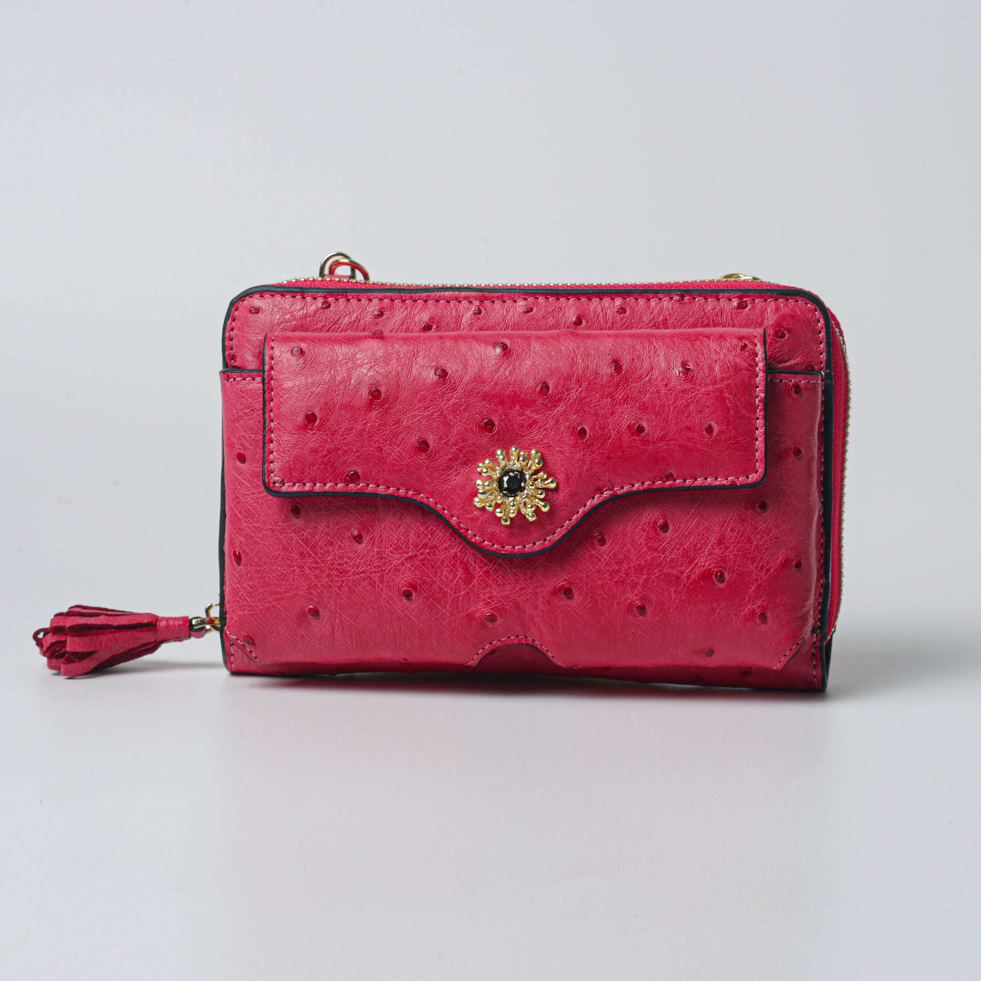 Raspberry bag made from 100% genuine ostrich leather with gold plated brass details, luxurious designer clutch.