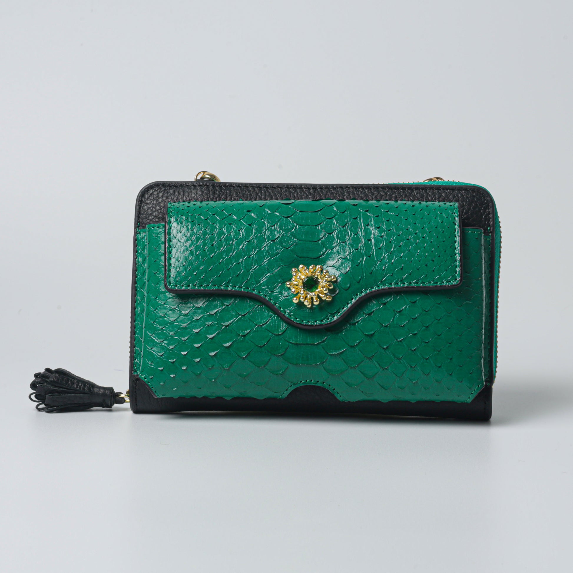 Handmade raspberry bag in green python leather with elegant clutch style, luxury craftsmanship, and gold-plated details.